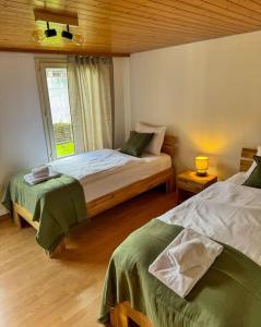 a bedroom with two beds and a window at City Center View Apartment in Interlaken