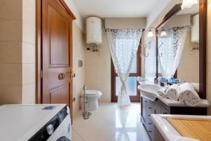 un bagno con lavandino e WC di La Casa di Tonina a Quartu SantʼElena Altre 57 foto