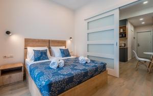 a bedroom with a bed with blue and white sheets at New Gudauri Geoflats in Gudauri +16 photos