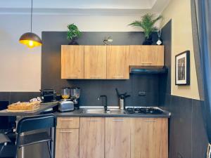 a kitchen with wooden cabinets and a sink at Falco Luxury Home - Naples Airport in Naples +52 photos