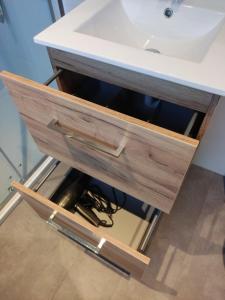 a bathroom sink with a drawer under it at Sallands Chalet met Hottub en Sauna in Haarle +60 photos