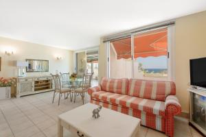 a living room with a couch and a table at Azahara Beach in Arona