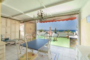 a dining room with a table and a view of the ocean at Azahara Beach in Arona