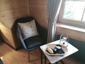 a small room with a chair and a table and a table sidx sidx at Exclusive Forest House - Spiska Leśna Przystań in Łapsze Niżne
