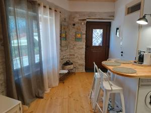 a kitchen with a table and chairs and a door at Casa Lehovo in Lechovo
