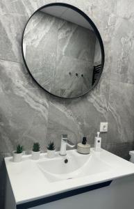 a bathroom with a white sink and a mirror at Studio46 in Klaipėda