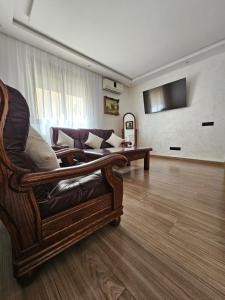 a living room with a couch and a tv at Luxury Appartement With Fibre Optique, Parking & Marina Swimming Pool 10 Min By Car in Agadir