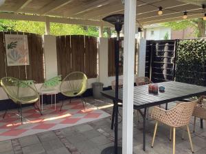 a table and chairs sitting on a patio at Waltrilo in Waalre