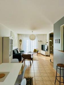 a living room with a couch and a table at Le Bon Compromis in Poitiers +10 photos