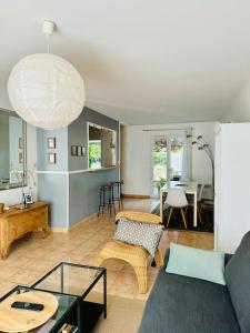 a living room with a couch and a table at Le Bon Compromis in Poitiers