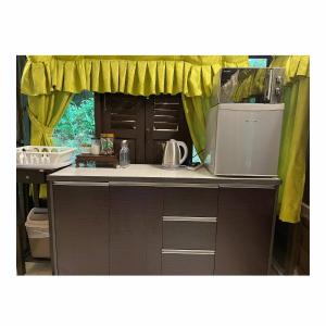 a kitchen with a sink and a refrigerator at Villa Sri Kampung in Kuah