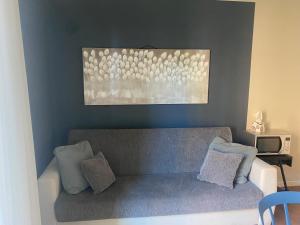 a living room with a couch and a painting at Sant'Orsola Malpighi Apartment in Bologna