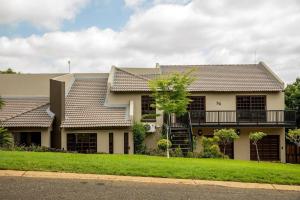 a house with a balcony on the side of it at Aloe room in Rustenburg +12 photos