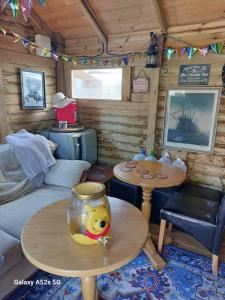 a living room with a table and a fish bowl on a table at Nest Guesthouse in Margate