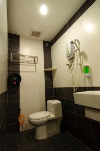 a bathroom with a toilet and a sink at T Hotel Kuala Perlis in Kuala Perlis