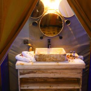 a bathroom with a sink and a mirror at Aladdin merzouga camp in Merzouga