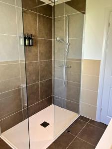 a shower with a glass door in a bathroom at The Studio in Eglinton +13 photos