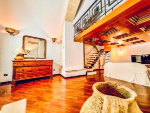 a bedroom with a staircase and a bed and a mirror at GALA Apartments - Charme Barocco a due passi da Piazza Duomo in Lecce