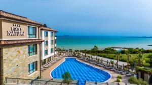 a view of a hotel with a swimming pool and the ocean at Natura All Seasons Boutique Hotel in Burgas City