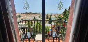 a balcony with two chairs and a view of a city at Hotel Nerja Club by Dorobe in Nerja +102 photos