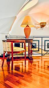 a table with a lamp on top of a room at GALA Apartments - Charme Barocco a due passi da Piazza Duomo in Lecce