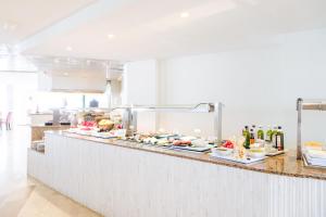 a buffet line with plates of food on it at Hotel Ankaa - Adults Only in Porto Cristo