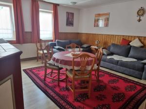 a living room with a table and chairs and a couch at Ferienwohnung Wacker, Apartments und Zimmer in Züschen