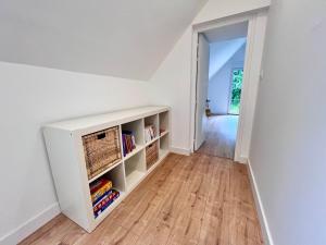 a room with white walls and a book shelf at La longère de Ty Pors in Combrit