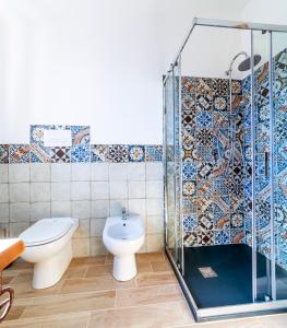 a bathroom with a toilet and a shower stall at BeB MaLú in Torpè