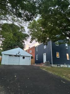 a building with a white garage next to a house at Single home, 4 beds, 2 baths in Silver Spring