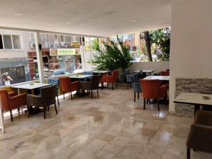 a restaurant with tables and chairs in a restaurant at Atlas Pansıyon in Antalya