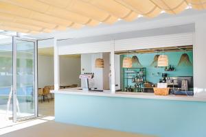 a bar with a view of the kitchen and dining room at Hotel Ankaa - Adults Only in Porto Cristo