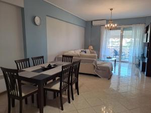 a living room with a table and chairs and a couch at Victoria's house in Kalamata