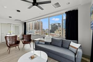 a living room with a couch and a large window at 175 LEX - Walkable Downtown Lexington & Rupp Arena - Full Condos in Lexington