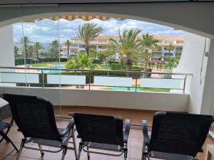 two chairs in a room with a view of a resort at Torresnostra see experience in Torreblanca