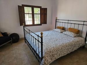 a bedroom with a bed in a room with a window at Villa Finca el Carril in Vélez de Benaudalla +37 photos