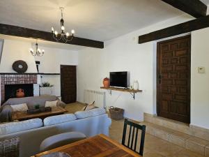 a living room with a couch and a fireplace at Villa Finca el Carril in Vélez de Benaudalla