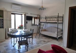 a living room with a table and two bunk beds at Dimora dei Cardinali in Agropoli