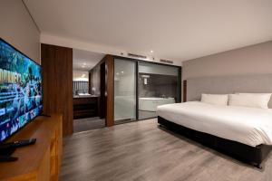 a bedroom with a bed and a flat screen tv at KIM Apartment & Homestays in Hanoi +19 photos