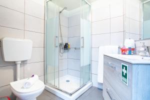 a bathroom with a shower and a toilet and a sink at Casa da Avó in Machico +22 photos