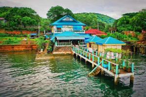 a house on a dock in the water at Bellalouise Inn in Busuanga