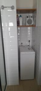 a small white bathroom with a small refrigerator at Suite Da Ninna 1 in Allai +16 photos
