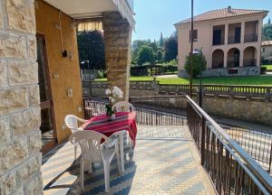 a table and chairs on the balcony of a house at Villa Cuten in Calco +4 photos