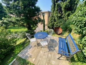 a blue table and chairs on a wooden deck at Villa Cuten in Calco