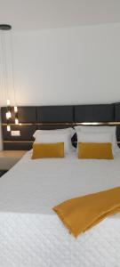 a large white bed with two pillows on it at Casa de Silvares - Piso inferior in Carvalho