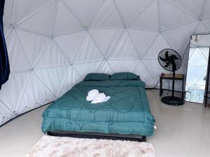 a bedroom with a bed in a tent at ภูเก็บตะวัน in Khao Kho
