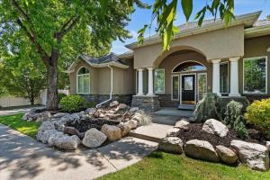 a house with a yard with rocks in front of it at Riviera Retreat in Salt Lake with Private Hot Tub and Theater in Millcreek