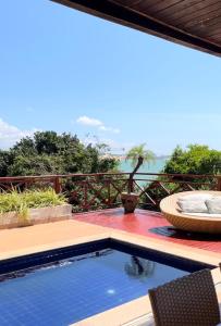 a swimming pool with a view of the water at Casa na praia em condomínio de luxo - Porto Brasil Resort in Parnamirim