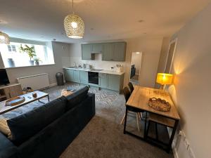 a living room with a couch and a table at Cosy Flat in Central Hexham in Hexham