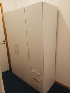 a pair of white cabinets in a room at Al-Xelb guesthouse in Silves